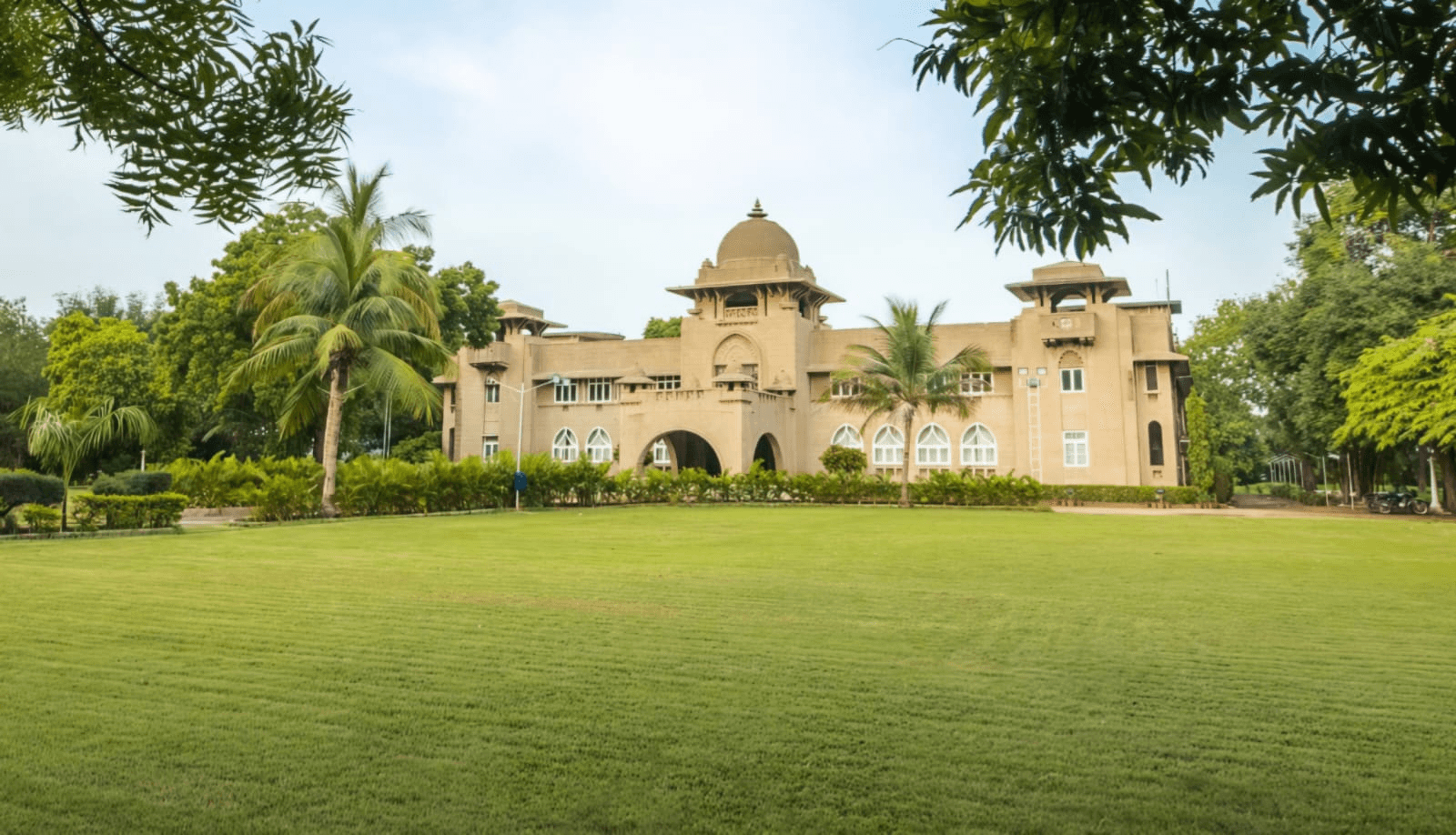 The ochre stone facade of Shivmahal Palace, a party plot and wedding venue in Vadodara