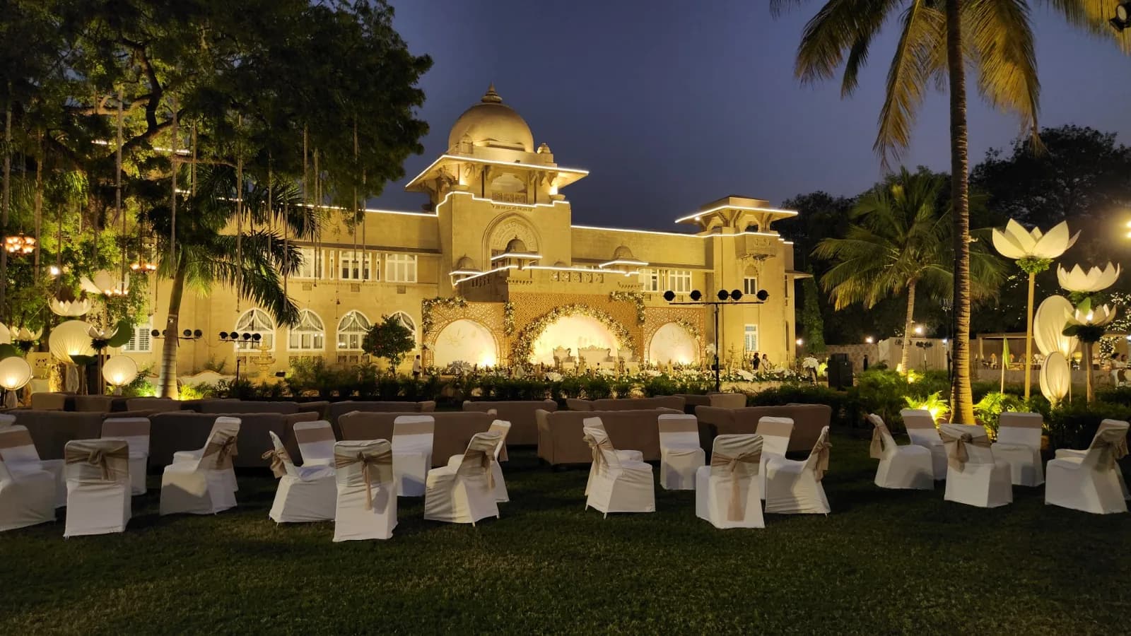 Reception seating on the lawn facing the illuminated Shivmahal Palace facade