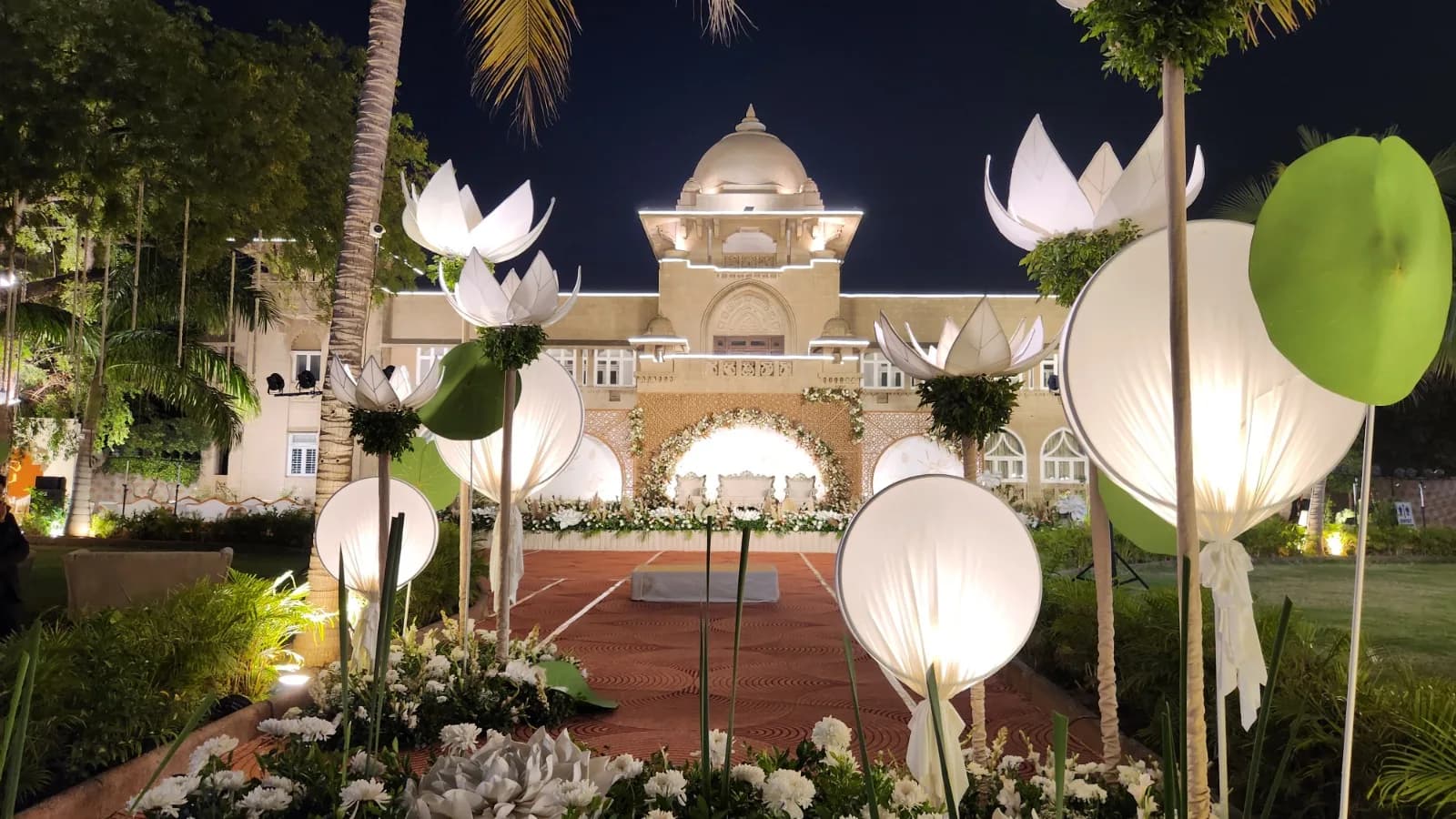 Lotus lantern installation around the stage in front of the lit palace facade