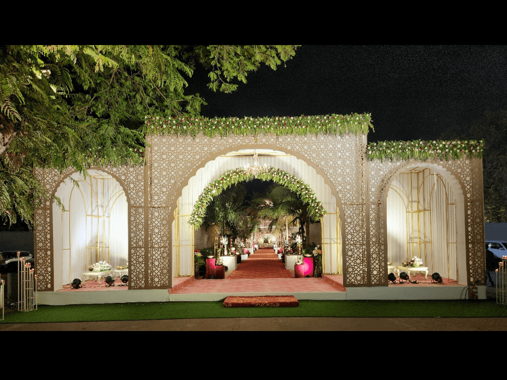 Ochre stone facade of Shivmahal Palace, a heritage wedding venue in Gujarat, lit after dark